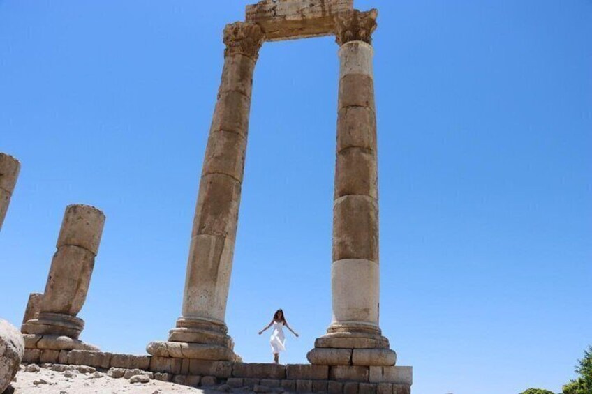 Ancient stone columns with a person standing in front of them. 2