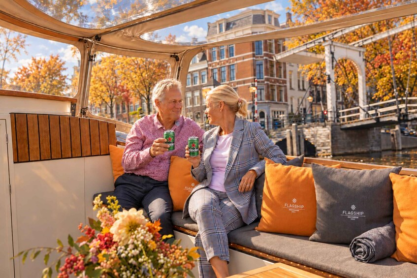Two people sitting on a boat with a cityscape in the background. 3