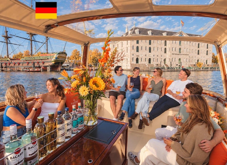 A group of people on a boat with a view of a historic building and a river. 1