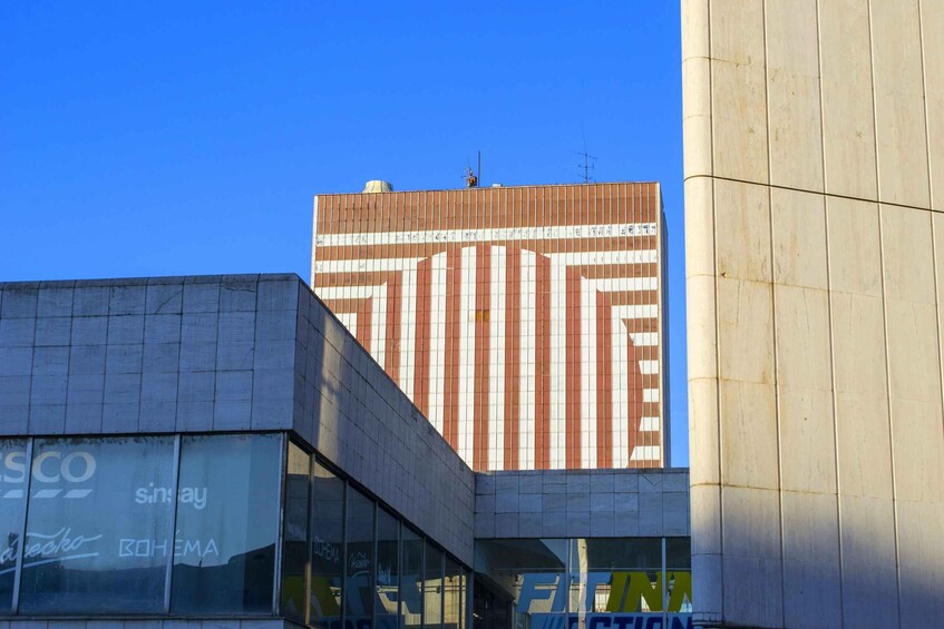 A modern building with a striped facade and a clear blue sky. 3