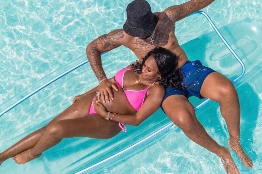 A person lying on a floating device in a pool. 3