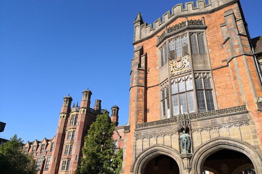 A historic building with red brick architecture, large windows, and a clock tower. 4