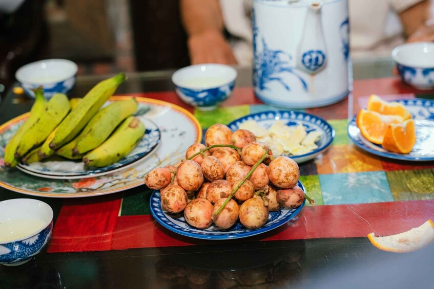A table with a variety of fruits and a teapot. 5