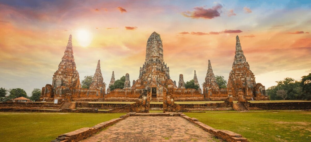 A temple complex with multiple tiered structures, a central entrance, and a surrounding moat. 1