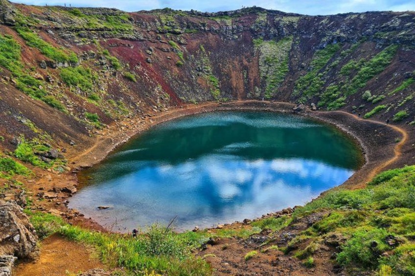 A crater lake surrounded by rugged terrain. 4