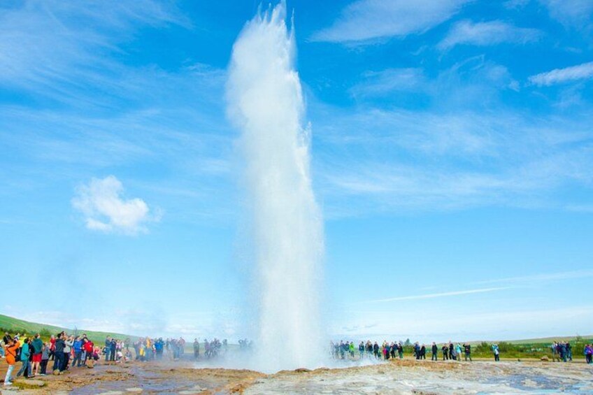 A geyser eruption with a crowd observing. 3