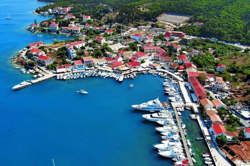A coastal town with a marina, boats, and houses with red roofs. 2