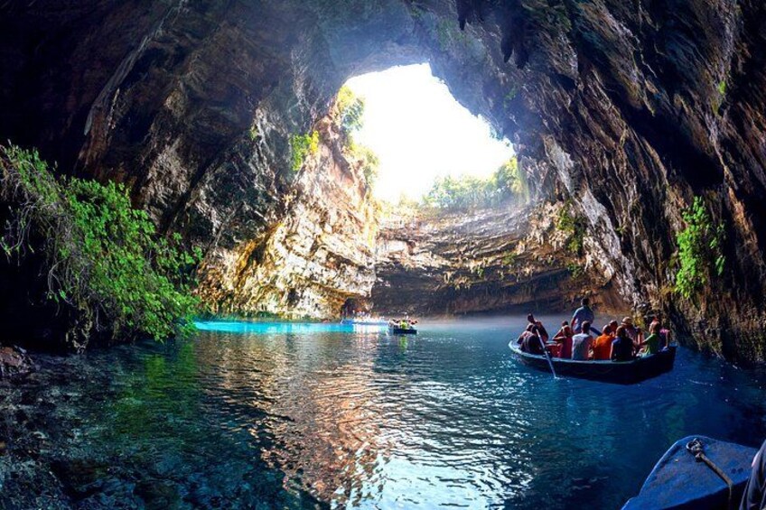 A boat tour through a cave with clear water and natural rock formations. 5