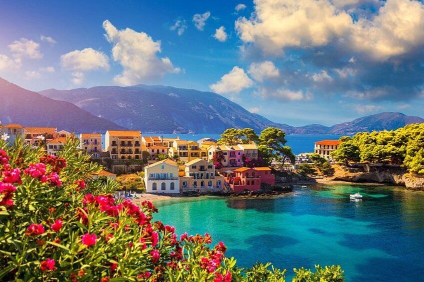 A coastal village with colorful buildings, clear turquoise waters, and mountains in the background. 3
