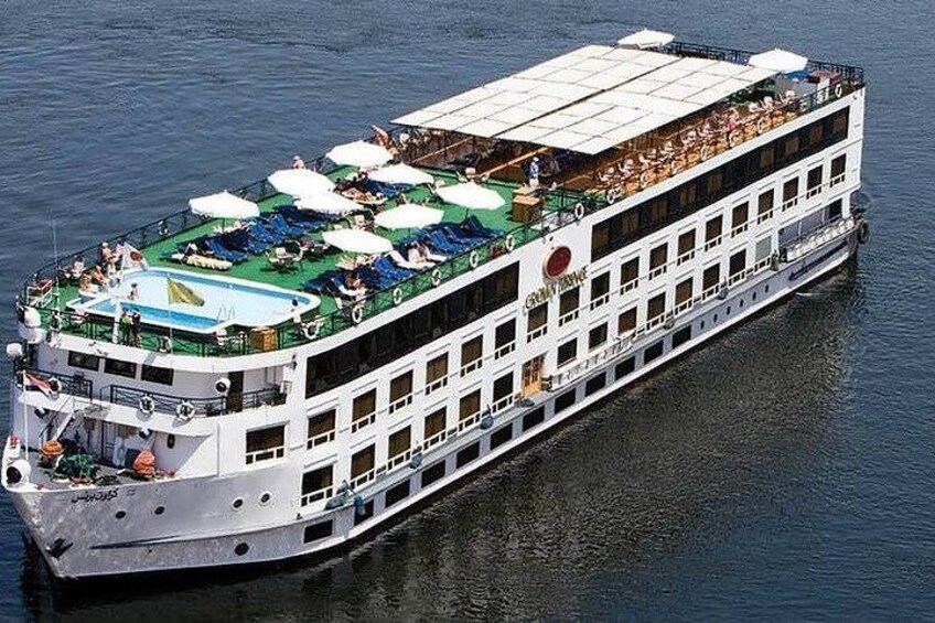 A river cruise ship with multiple decks, outdoor seating areas, and a swimming pool. 1