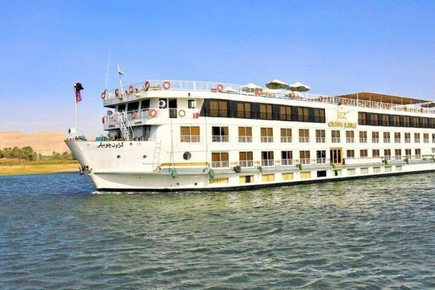A large white river cruise ship with multiple decks and lifeboats visible. 4