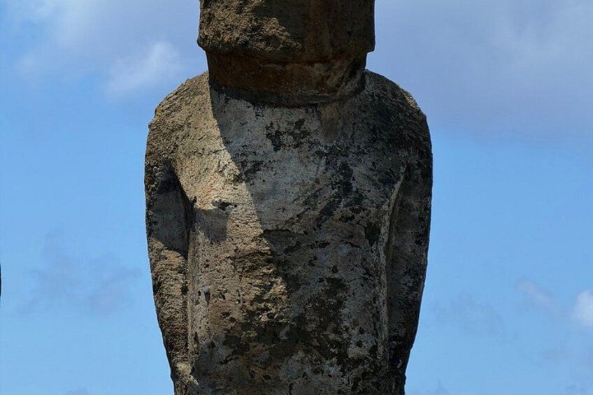 A large stone statue with a rough texture and weathered surface. 4