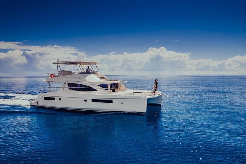 A large white yacht on calm blue waters with a clear sky. 1
