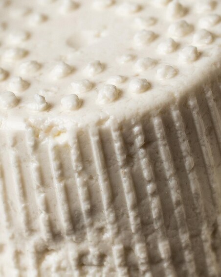 A close-up of a textured surface with a pattern of raised dots and vertical lines. 5