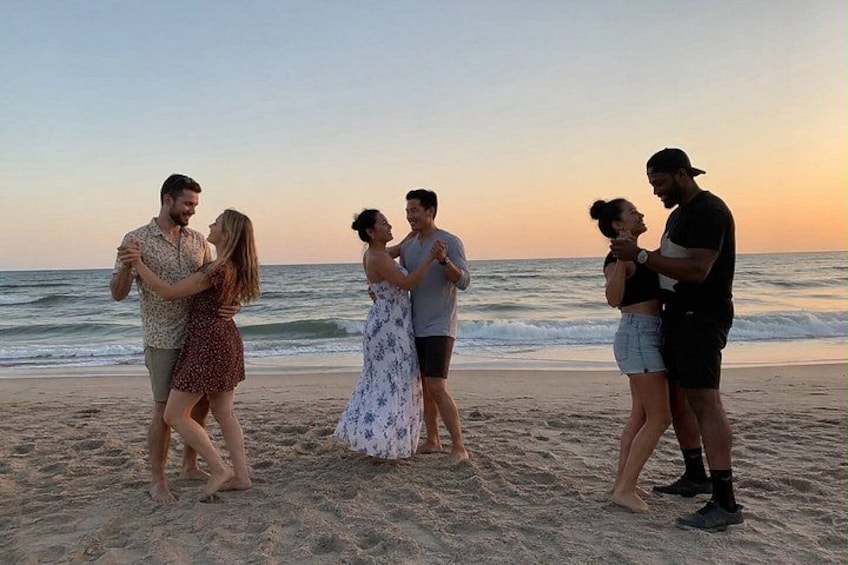 A beach with people dancing. 3