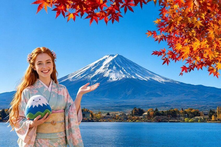 A person in traditional attire holding a snowman figure, with Mount Fuji in the background. 1