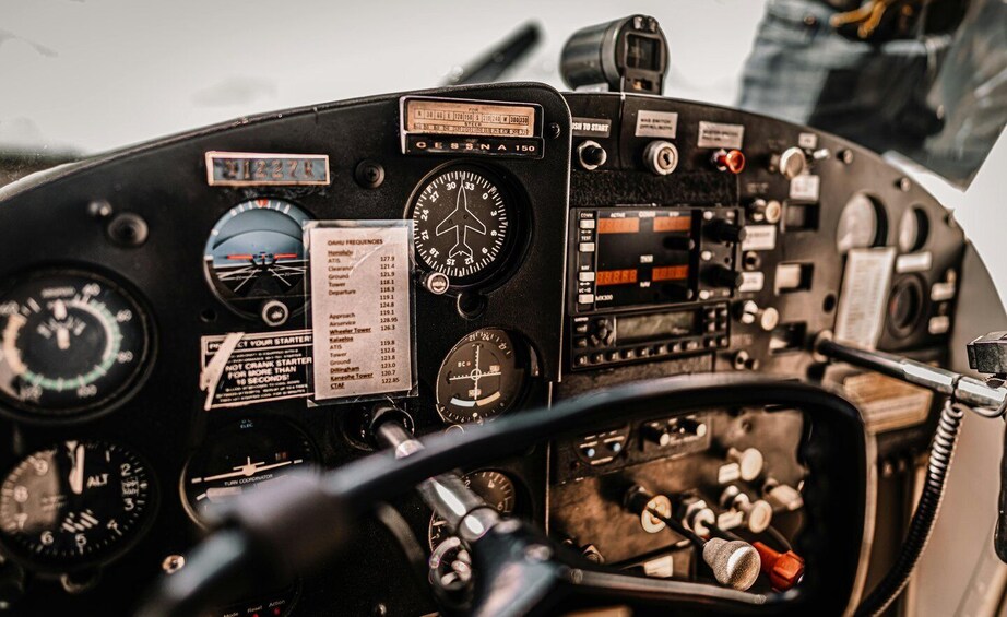 A cockpit with various dials, gauges, and a control panel. 4