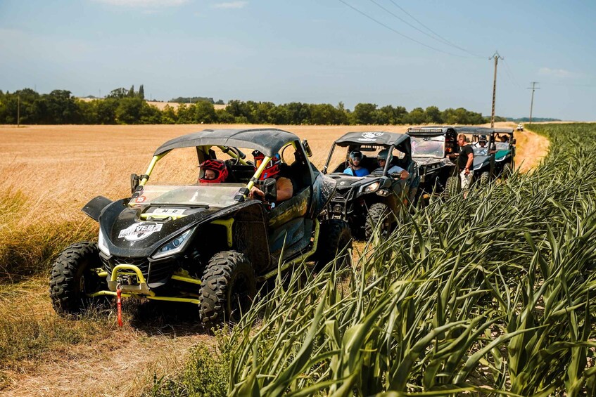 A line of off-road vehicles in a field. 2