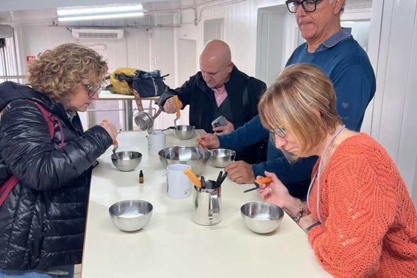 A group of people engaged in a cooking activity with bowls and utensils on a table. 4