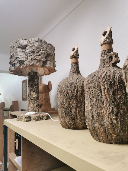 Three rustic, textured vases on a shelf. 3