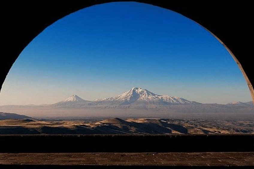 A snow-capped mountain range under a clear blue sky. 5