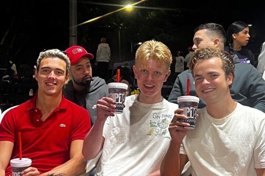 Three people holding drinks with visible logos. 2