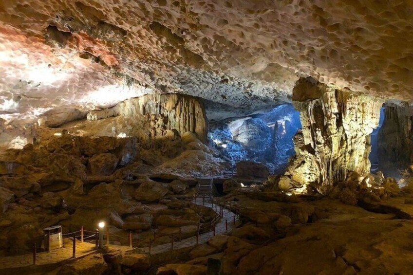 A cave with stalactites, a winding path, and a blue-lit background. 5