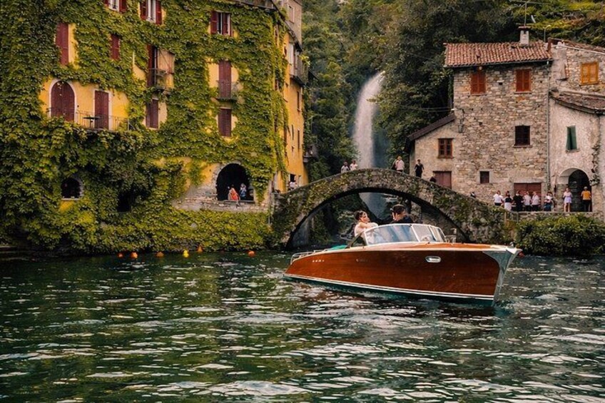 A boat on water with a bridge and buildings in the background. 2