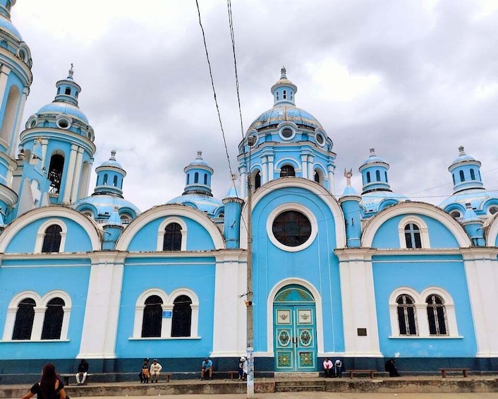 A large blue and white church with multiple domes and a central entrance. 1