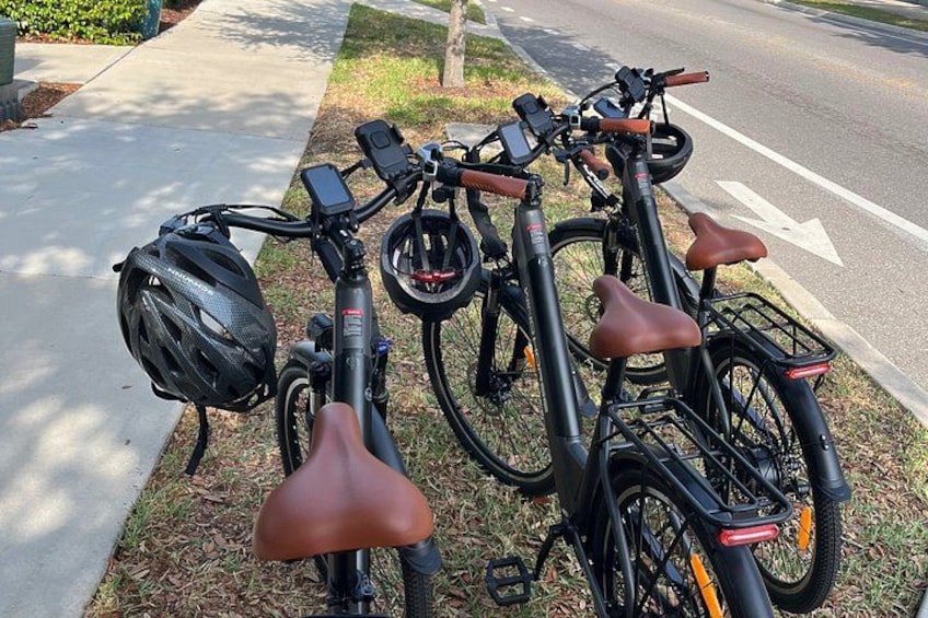 A row of bicycles parked on a sidewalk. 5