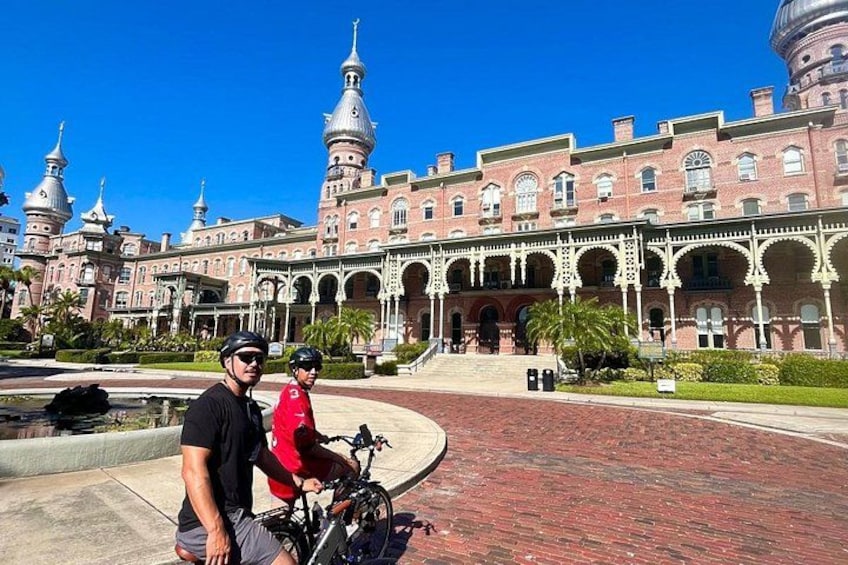 A historic building with domed towers and a courtyard. 3
