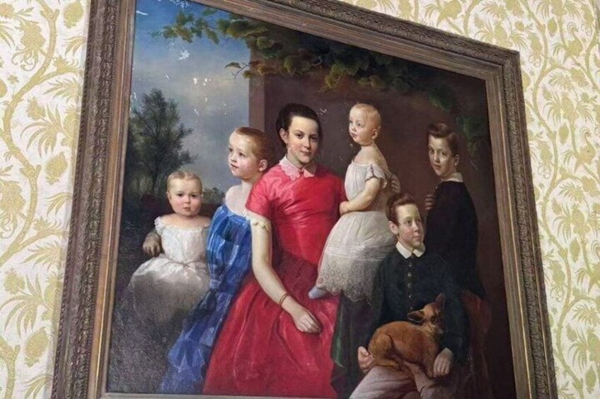 A portrait painting with a family, a dog, and a child on a bench. 1