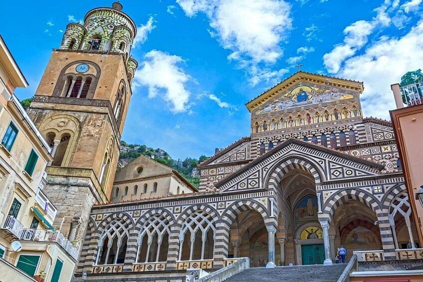 A historic building with ornate architecture, including a clock tower and a detailed facade. 1