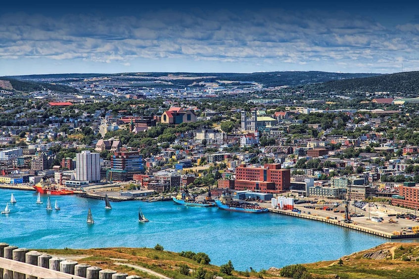 A coastal cityscape with a harbor, sailboats, and a mix of residential and commercial buildings. 2