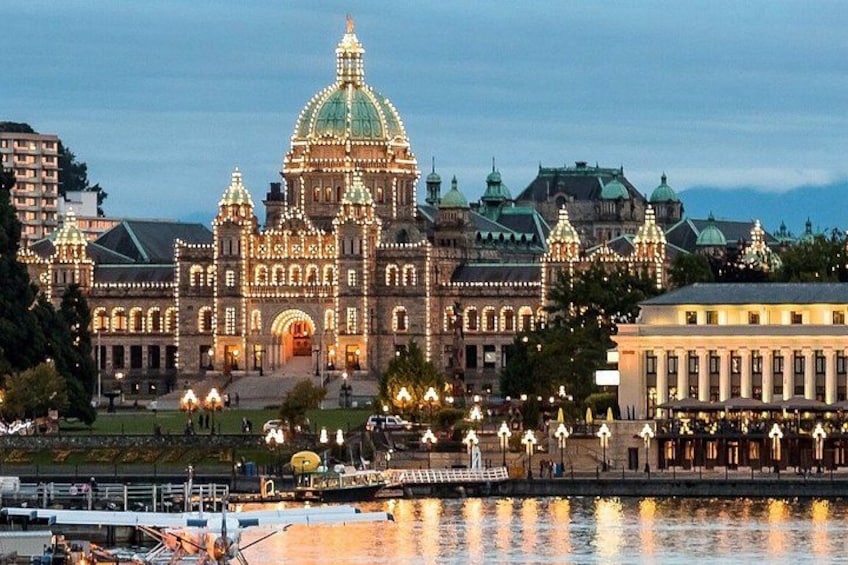 A grand, illuminated building with a large dome and multiple towers, situated by a waterfront. 3