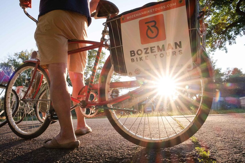 A red bicycle with a 'Bozeman Bike Tours' sign attached to the front wheel. 4