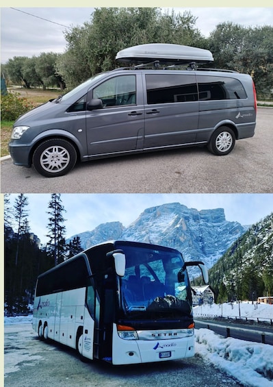 A gray minivan with a roof carrier and a white bus with 'SETRA' branding parked in a snowy landscape with mountains. 2