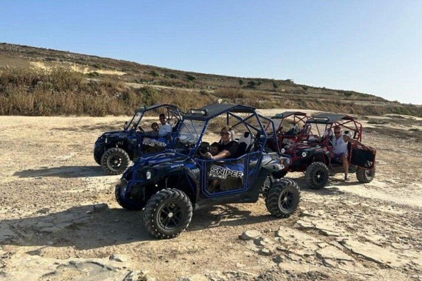 Off-road vehicles on a sandy terrain with a clear sky. 4