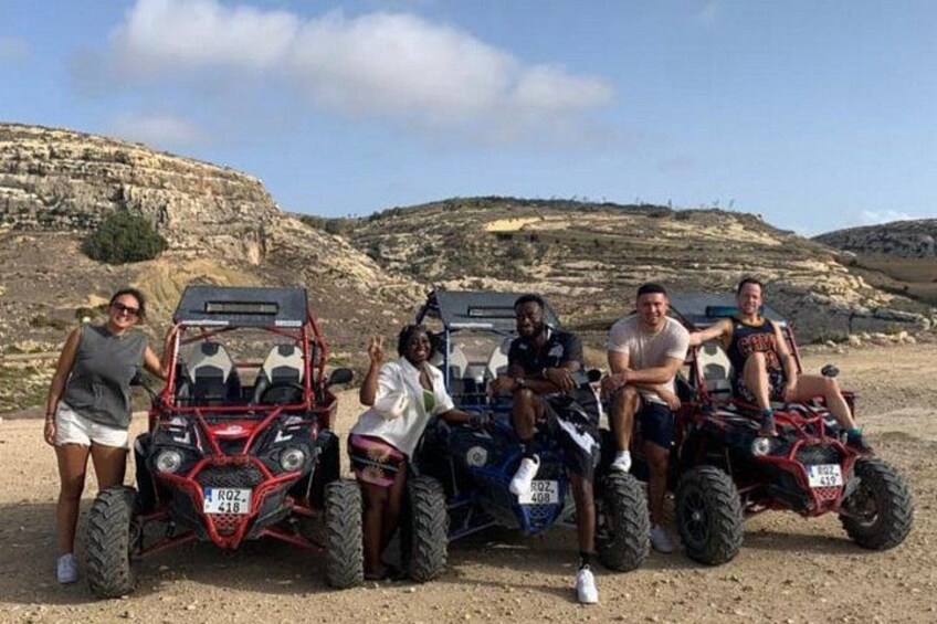 A group of people on all-terrain vehicles in a rocky outdoor setting. 3
