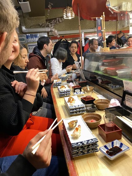 People dining at a restaurant with various dishes and drinks. 5