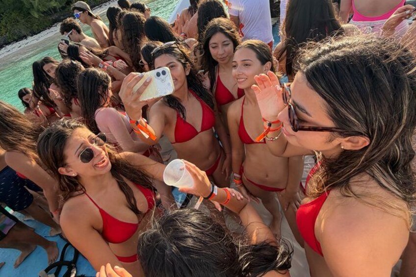 A group of people in red bikinis by a pool. 2