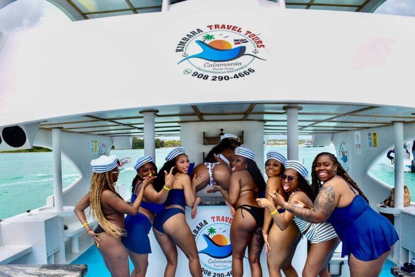A group of people on a boat with a logo for 'Kimbara Travel Tours' and contact information. 4