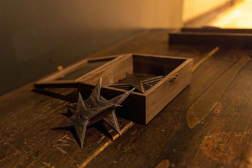A wooden box with a star-shaped object inside. 2