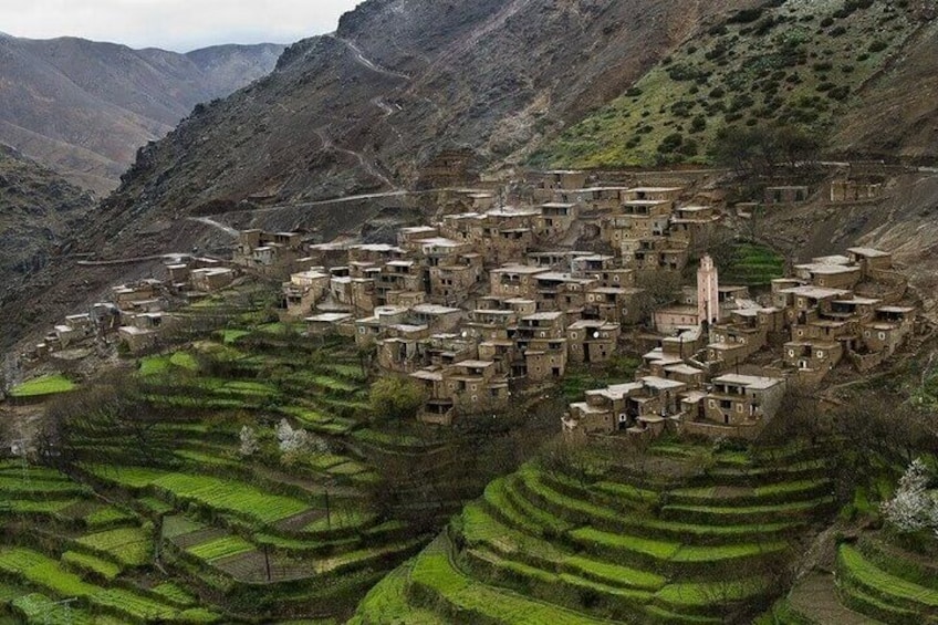 A village nestled in terraced fields with a prominent church. 4