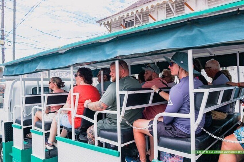 A group of people on a boat with a covered deck. 5