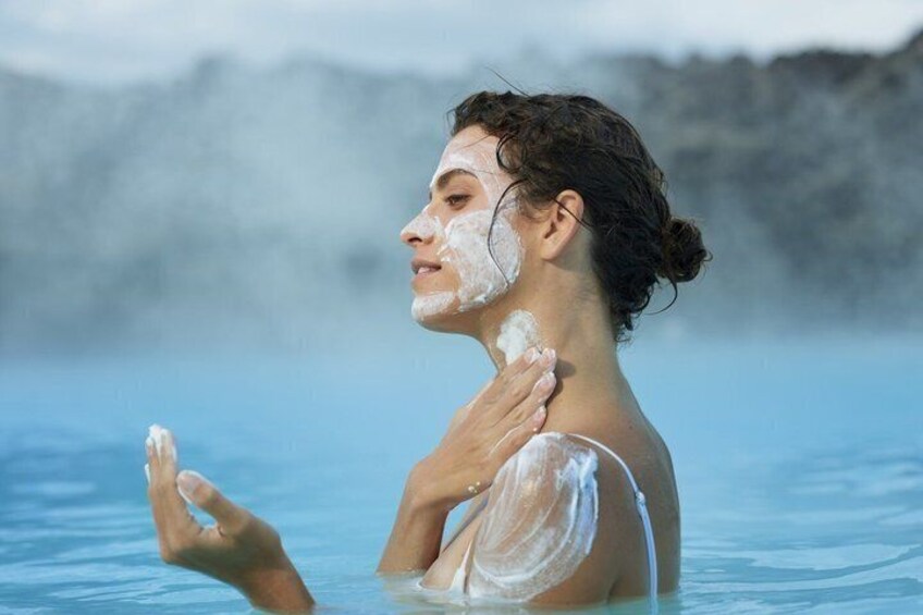 A person in a geothermal spa with steam rising from the water. 5