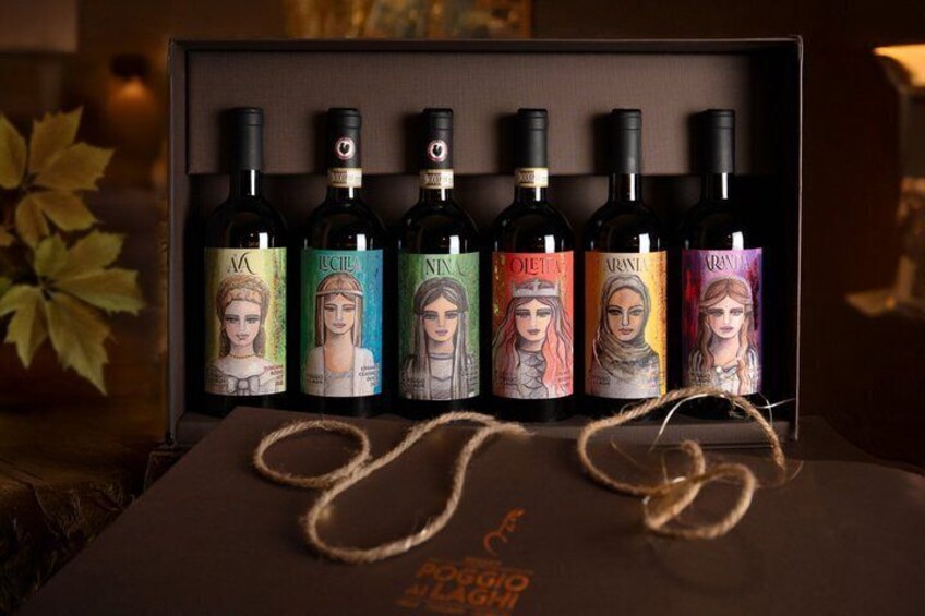 A box of wine bottles with unique labels, a rope, and a leaf in the background. 2