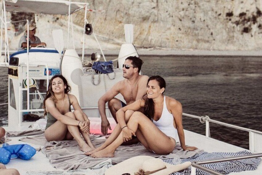 A group of people on a boat near a rocky coastline. 2