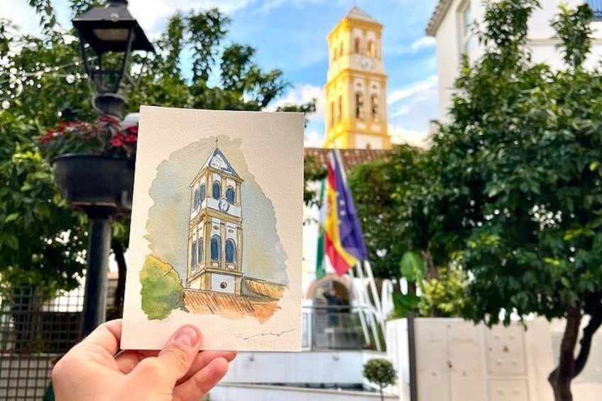 Una mano sostiene una pintura a técnica mixta de una torre, con una bandera y vegetación al fondo. 4