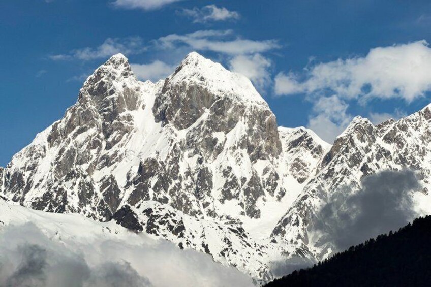 Snow-covered mountain peaks under a clear sky. 2